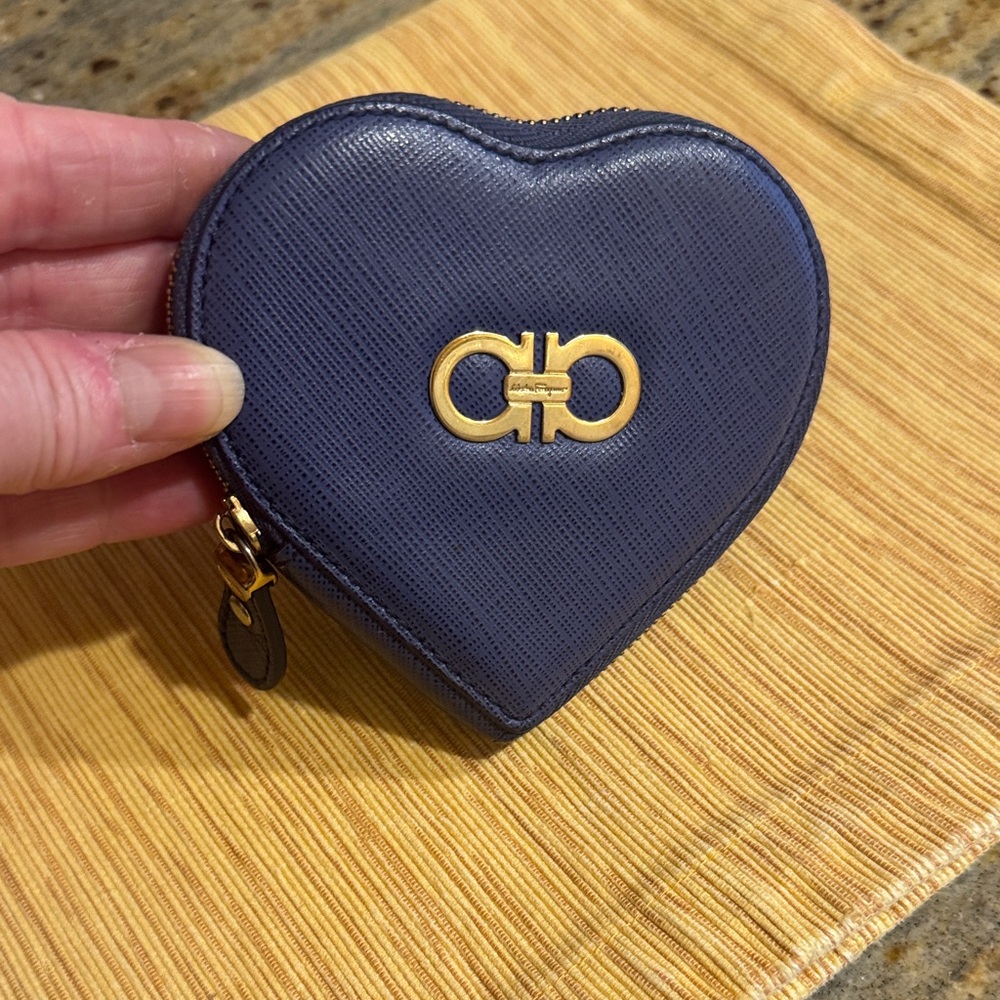 Salvatore Ferragamo Navy Heart Coin Pouch comes with gold hardware.